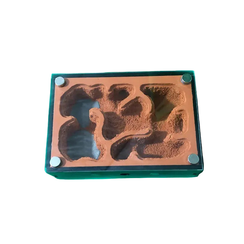 Magnetic glass lid open on ant nest chamber showing gypsum substrate tunnels